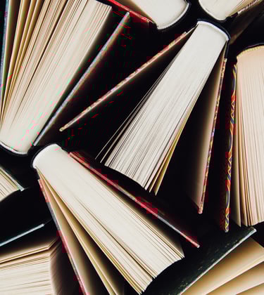 Overhead shot of stacked books representing bold literary work.
