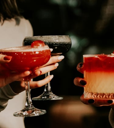 Group of women clinking drinks symbolizing Single Girl’s Guide lifestyle series