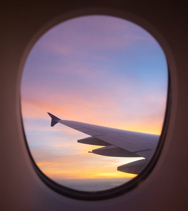 Airplane window view symbolizing Sarah Melland’s travel books and guides