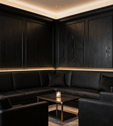 An intimate and elegant private lounge for client consultations, featuring deep black wood paneling and light gold accents. Professional European / Swiss atmosphere, exclusive and confidential vibe.