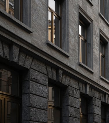 Close-up architectural photography of a prestigious stone façade in the Champel district of Geneva. Minimalist aesthetic, luxury real estate, soft natural morning light. Deep black and gold accents. European Swiss style.