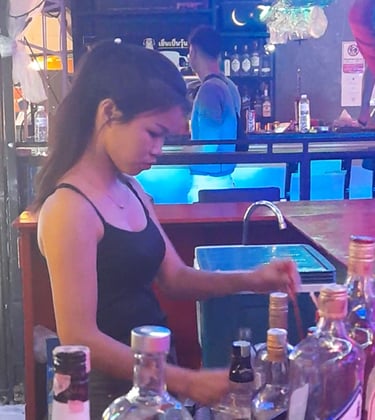 Thai woman preparing drinks at bar in Wonderland, Hua Hin