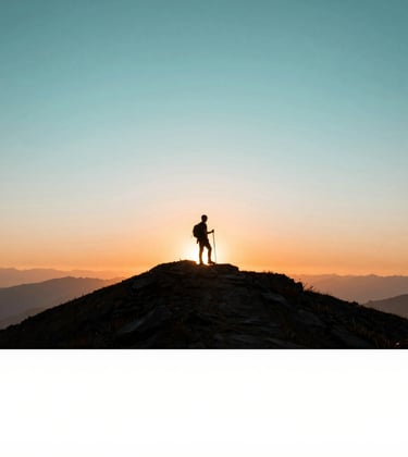 A person hiking on a ridge at sunset, silhouetted against a breathtaking sky of #A8C9CF and soft orange. The composition conveys adventure and freedom.