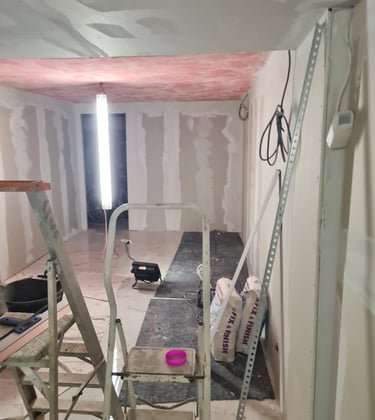 Travaux intérieurs en cours : pose de cloisons en plaques de plâtre et préparation des plafonds