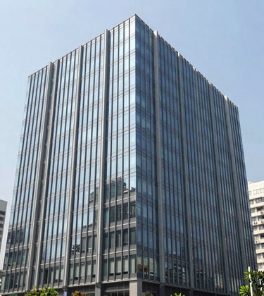 Modern glass-fronted commercial building in a bustling Indian business district. Sharp architectural lines, professional photography, bright daylight, and a clean grey and blue color palette reflecting modern development expertise.