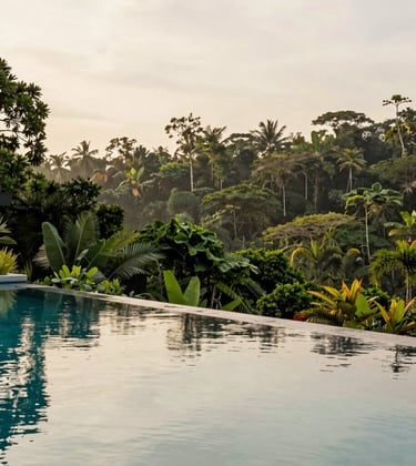 A serene private infinity pool at a luxury estate in Costa Rica, overlooking the deep forest green of the jungle. The water reflects the creamy off-white sky, evoking a sense of calm and opulence. High-end real estate photography.