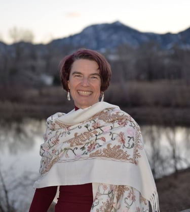 Kassandra white shawl water mountains. Photo by Kaylyn B