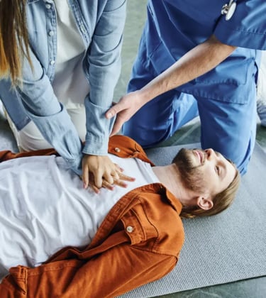 Training CPR on a man laying on the ground