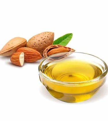 a bowl of almond oil with almonds and almond oil
