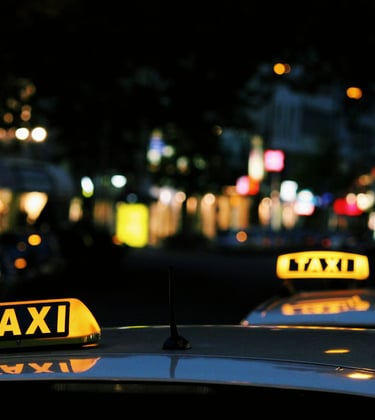 Taxi sign on a black roof of a vehicle