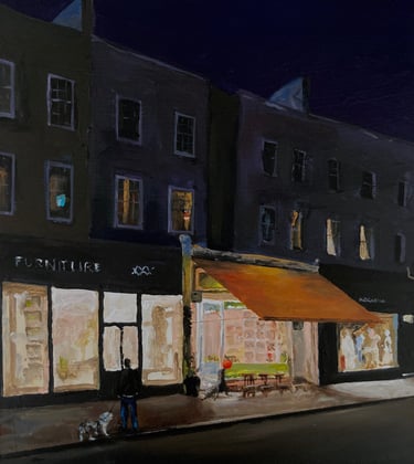 an early evening scene in London. a man is walking a dog and seal plays with ball outside a cafe