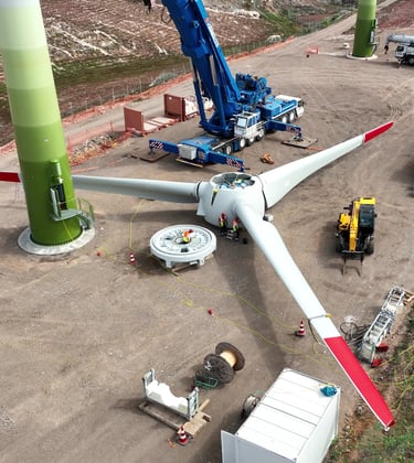 a wind turbine being worked on by a crane