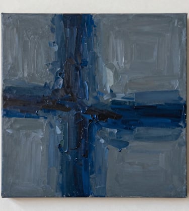 A close-up photograph of a contemporary abstract oil painting on canvas. The texture of heavy brushstrokes in navy blue and slate grey is illuminated by soft, side-angled gallery lighting. North American / International style.