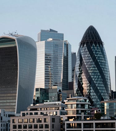 A sleek, sharp photograph of the London financial district skyline. The Gherkin and other modern structures are visible under a soft morning sun. The color palette emphasizes professional deep slate blue-grey and soft off-white reflections.