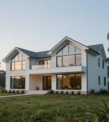 A sophisticated modern farmhouse with large glass windows and clean lines, situated on a grassy hill in a North American / Southern US landscape, featuring soft blue-grey and pale misty white colors in the building materials.
