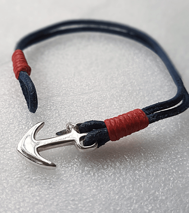 a bracelet bracelet with a silver anchor on a white background