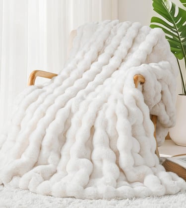 a white blanket on a chair in a room