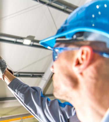 crane inspector looking at overhead crane hook and rope