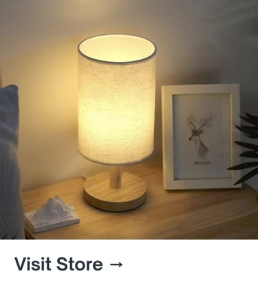 Small table lamp with a fabric shade creating a warm, soft glow