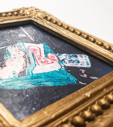 a close-up photo of a miniature painting magnet in a gold gilded frame