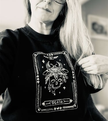 a tarot design sweater, white thread on a black sweater