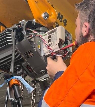 crane technician inspecting and adjusting electrical components