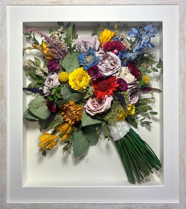a Side view Style bouquet of flowers  in a thin white frame
