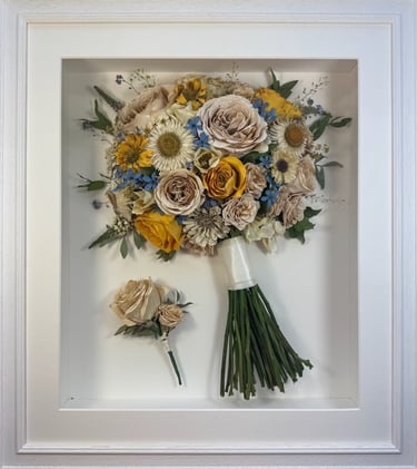 a Side view Style bouquet of flowers with buttonhole in a ridged white frame