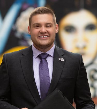 A man standing with a binder