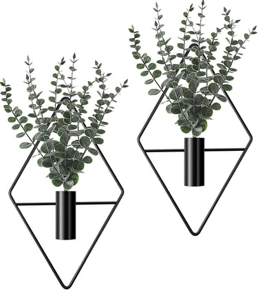 Set of two wall-mounted black geometric diamond vases with artificial eucalyptus greenery for modern home decor.
