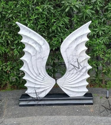 a pair of white sculptures of wings
