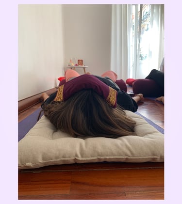 A workshop participant with an eye pillow over their eyes during a guided meditation in Lisbon.