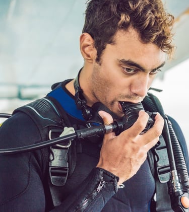 a man in a scuba suit prepair for dive