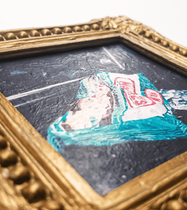 a close-up photo of a miniature painting magnet in a gold gilded frame