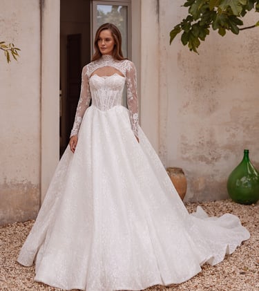 a woman in a wedding dress standing in front of a building