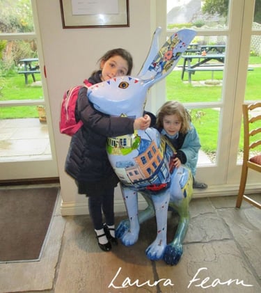 Large Hare sculpture painted with street scenes of Cirencester