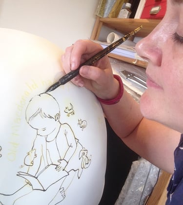 Laura Fearn painting an owl for Owls of Bath