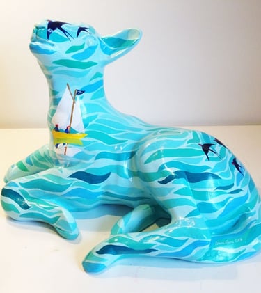 Small sculpture of a lamb featuring a Swallows and Amazons design by Laura Fearn