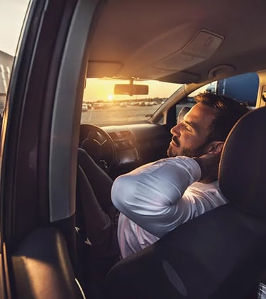 Relaxed car driver with closed eyes chilling in his vehicle