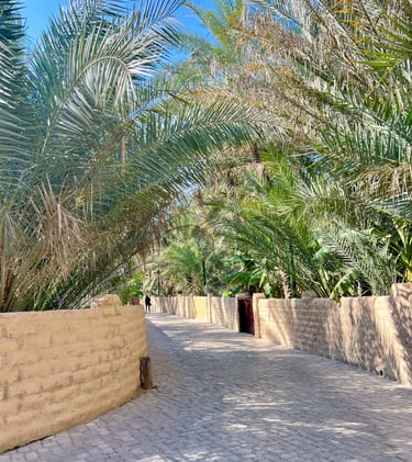 a brick wall with palm trees and a brick wall Al Ain Oasis