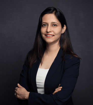 Dr Anam in a black suit and white top
