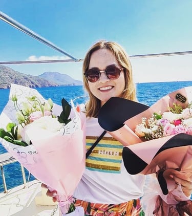 a Japanese woman holding a bunch of flowers on a boat