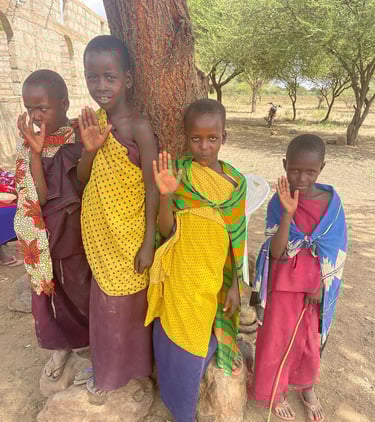 a group of children standing around a tree