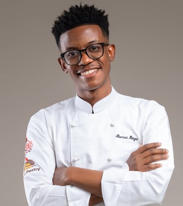 a man in a chef's uniform and glasses