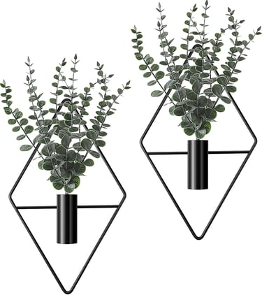 Set of two wall-mounted black diamond geometric planters with artificial eucalyptus greenery for modern home decor.