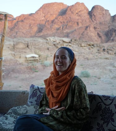 Woman smiling with a backdrop of mountains