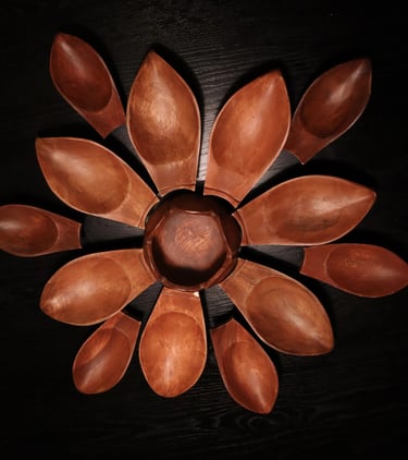 Rustic antique curved wooden stool on a light timber floor with linen curtains in the background.
