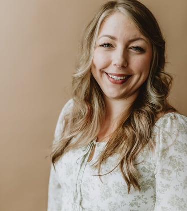 a woman with blonde hair and a white shirt