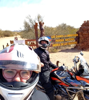 a man and woman on a motorcycle with helmets