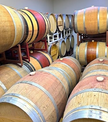 Brown and tan wine barrels stacked on racks